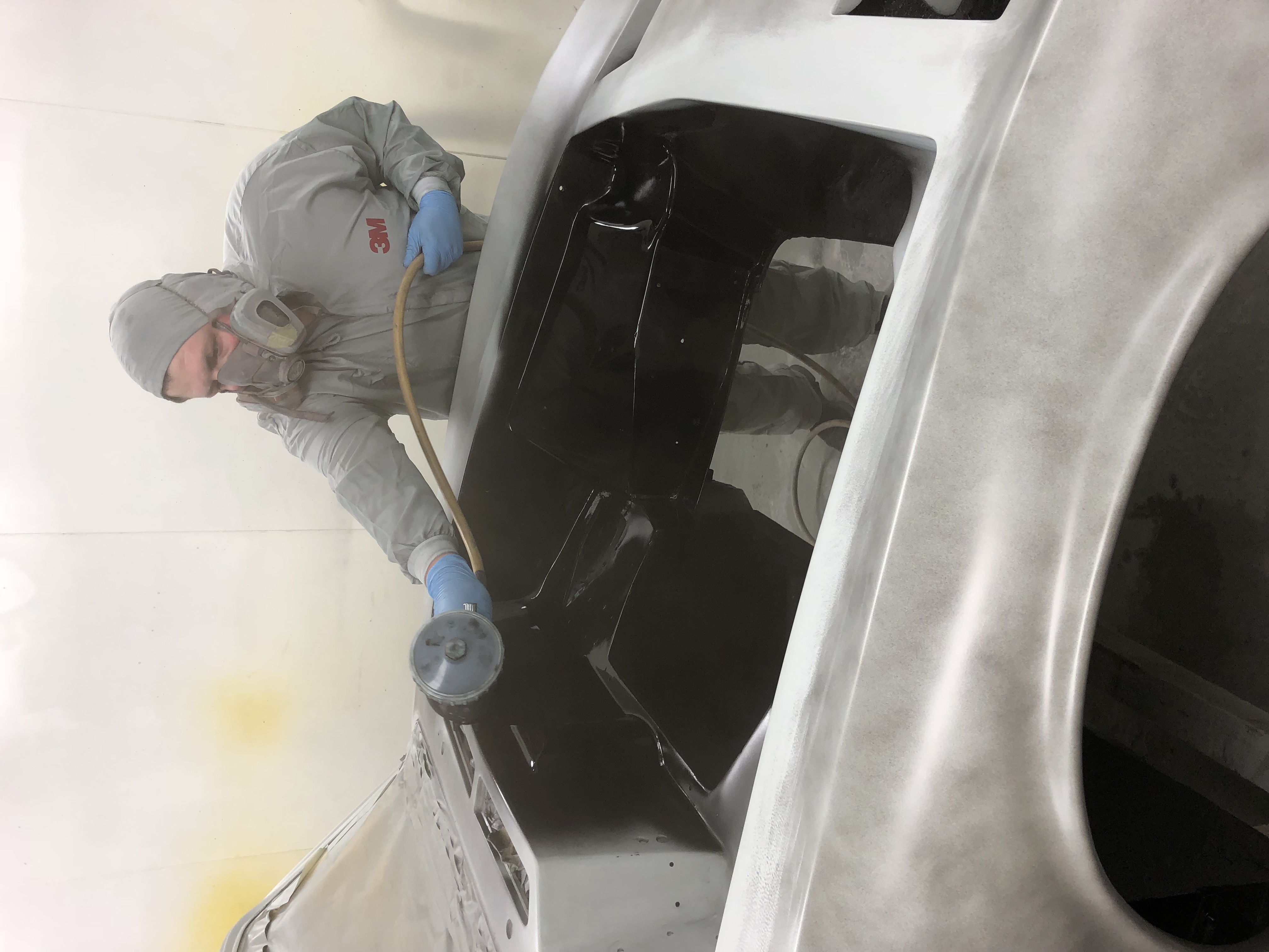 Sixteen80 technician working on a vehicle body in the paintshop